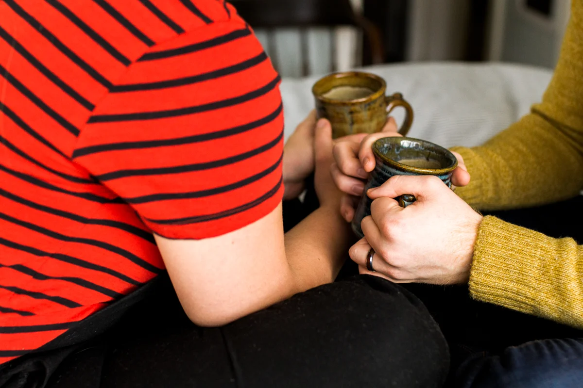 sharing coffee together during an intimate in-home couples session in Kansas City, MO