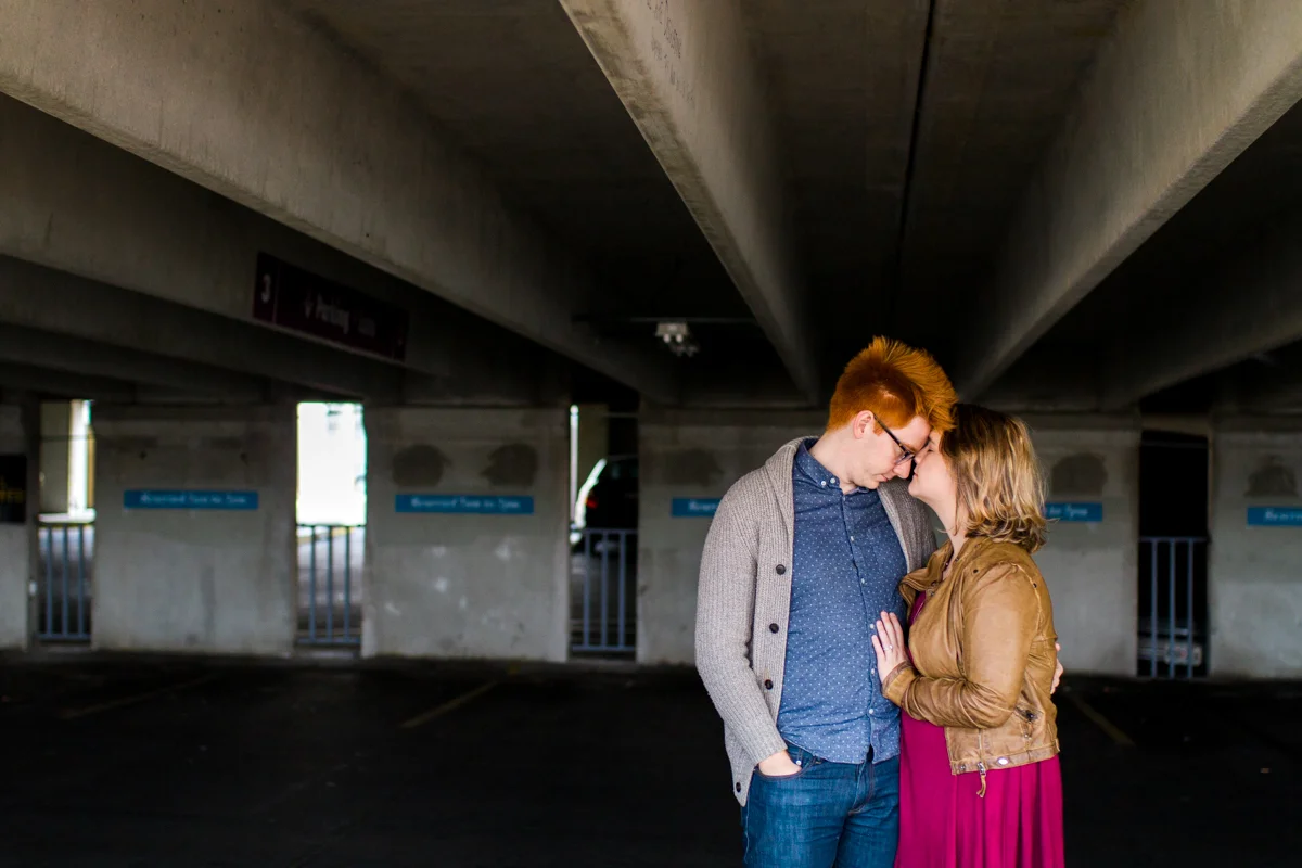 engaged or married couple cuddle in a parking garage in Westport Kansas City, MO