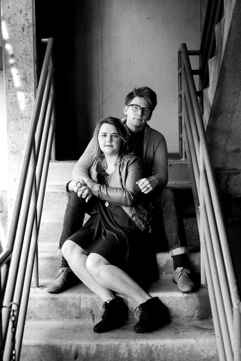 engaged or married couple sitting in a parking garage in Westport Kansas City, MO black and white photography