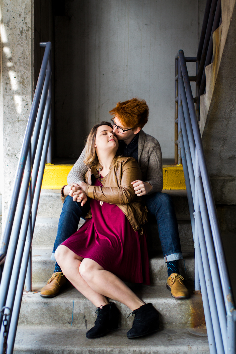  engaged or married couple cuddle in a parking garage in Westport Kansas City, MO 