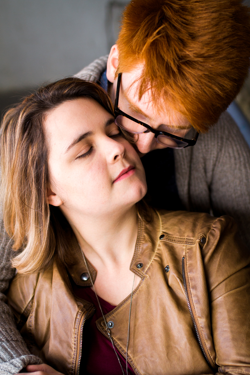  engaged or married couple cuddling in a parking garage in Westport Kansas City, MO close up 