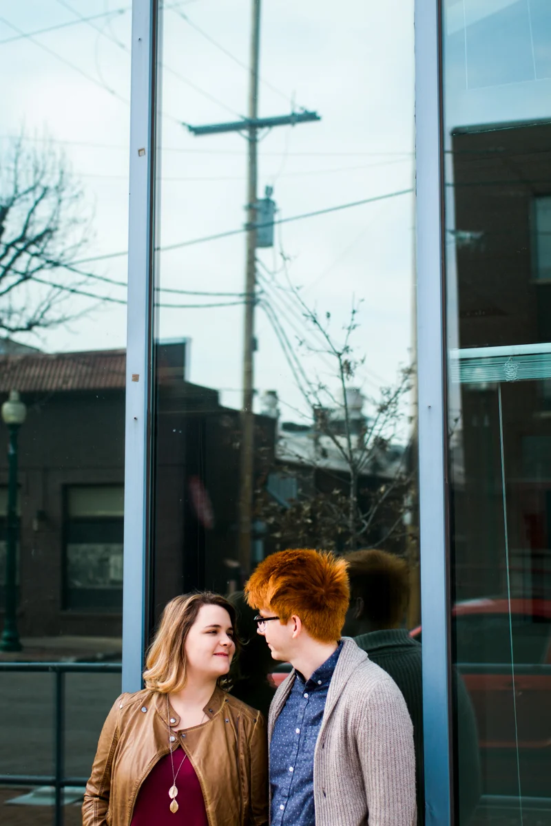 urban engaged or married couple reflected in a window engagment photography couples photography Westport Kansas City, MO