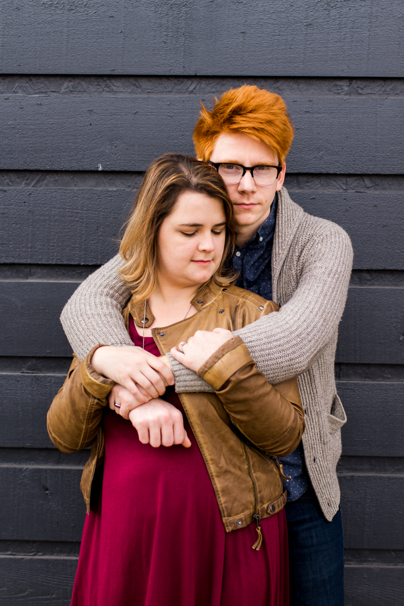  urban engaged or married couple leaning against gray wall engagment photography couples photography Westport Kansas City, MO 