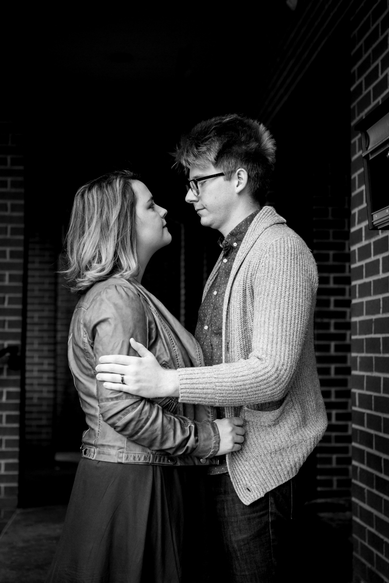  urban engaged or married couple standing under brick doorway photography couples photography Westport Kansas City, MO 