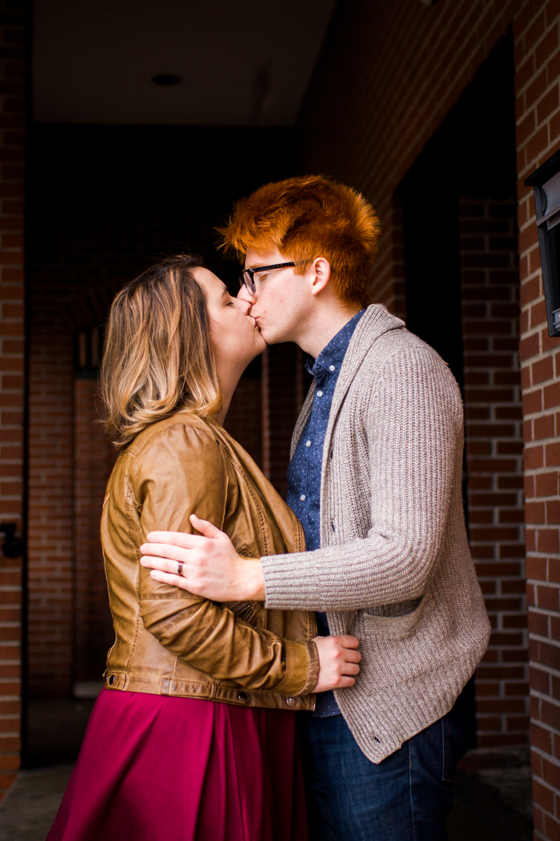  urban engaged or married couple kissing under brick doorway photography couples photography Westport Kansas City, MO 