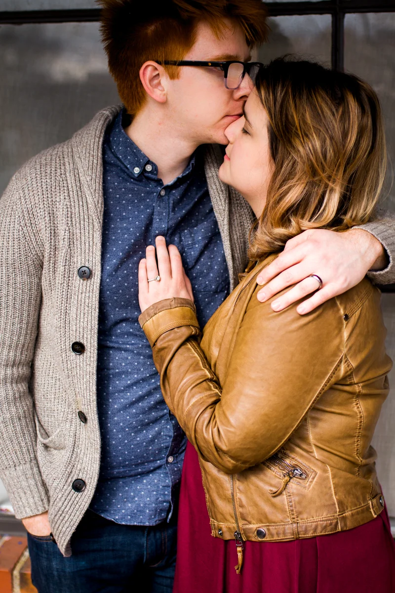 urban engaged or married couple standing by city shop window engagment photography couples photography Westport Kansas City, MO