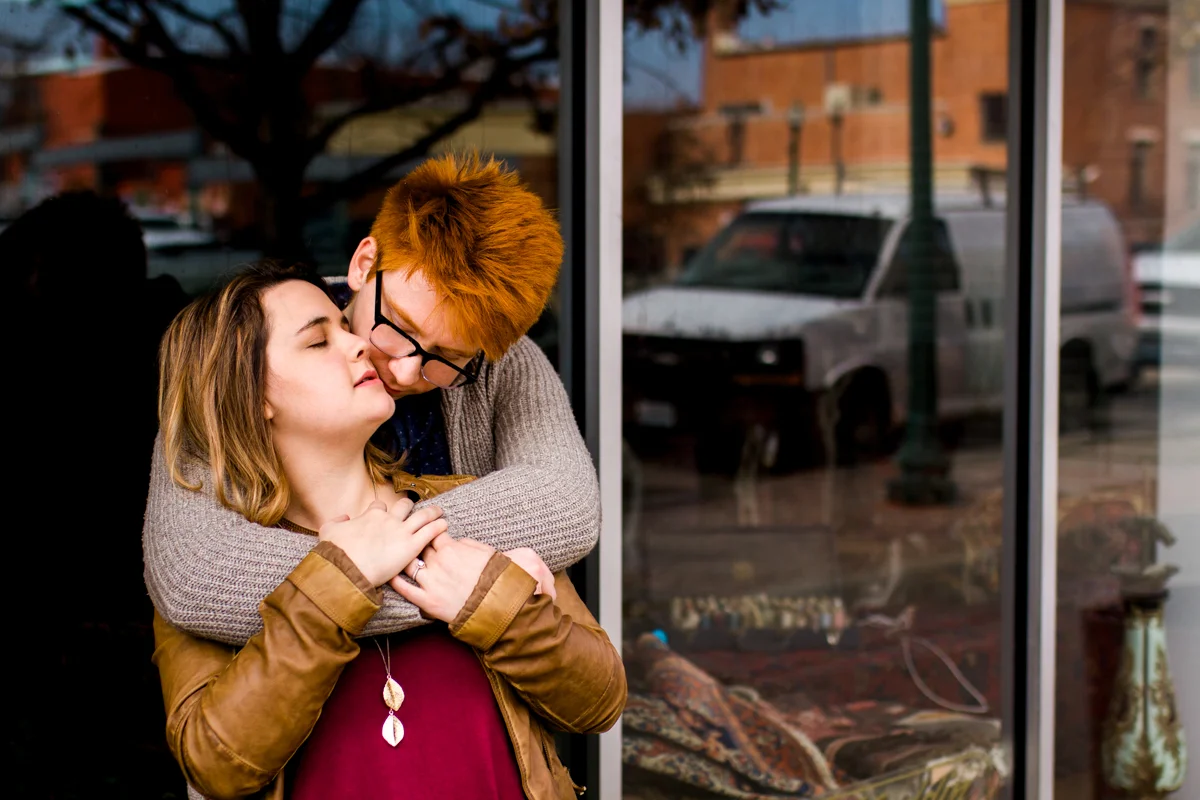 urban engaged or married couple reflected in city window engagment photography couples photography Westport Kansas City, MO