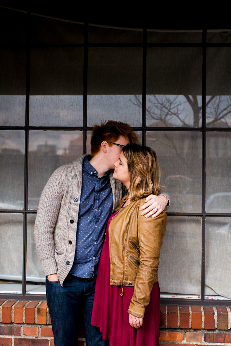  urban engaged or married couple standing by city shop window engagment photography couples photography Westport Kansas City, MO 