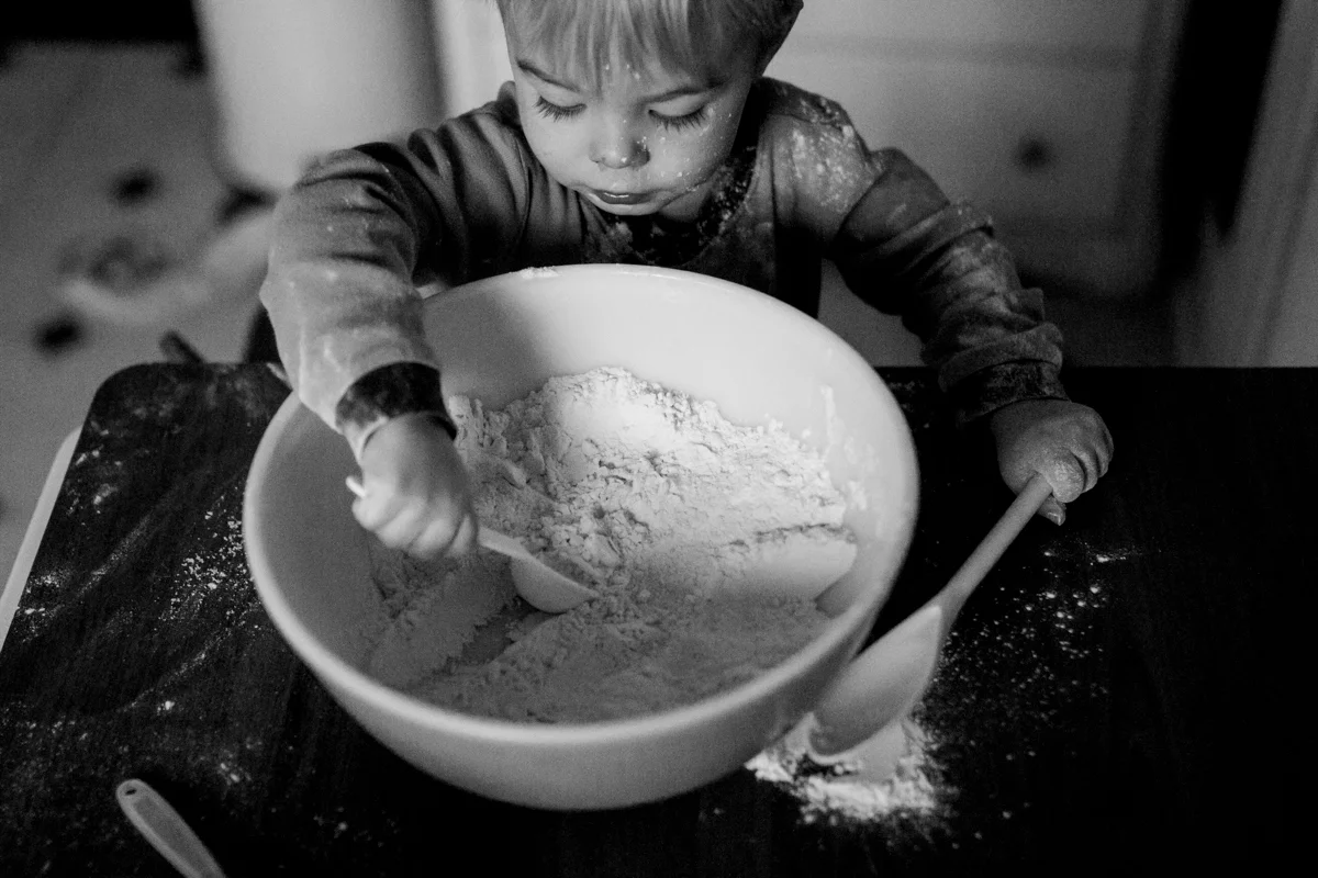 Kansas City, MO lifestyle family photographer boy cooking with mom family photography black and white photography