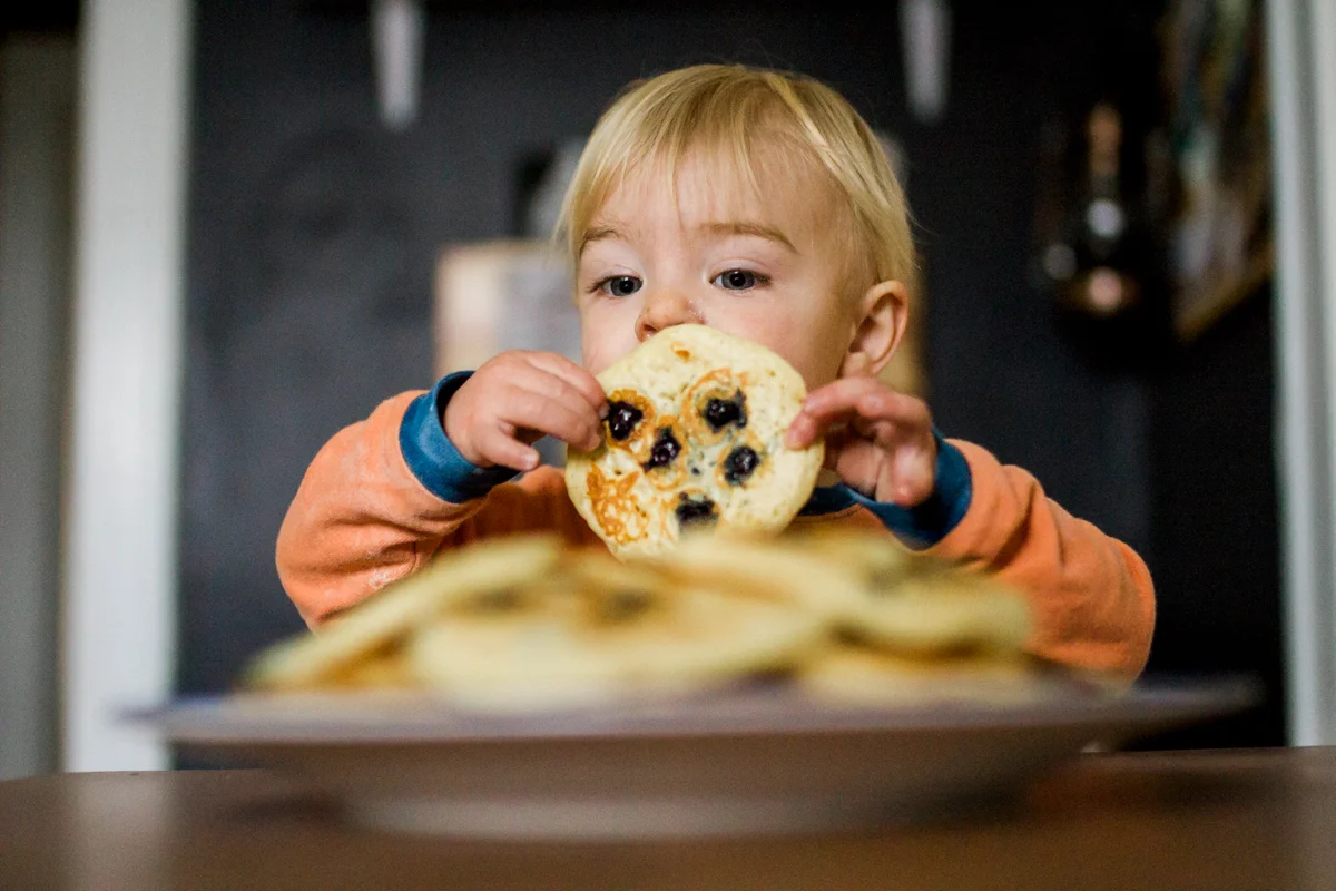 Kansas City, MO lifestyle family photographer boy with pancakes family photography