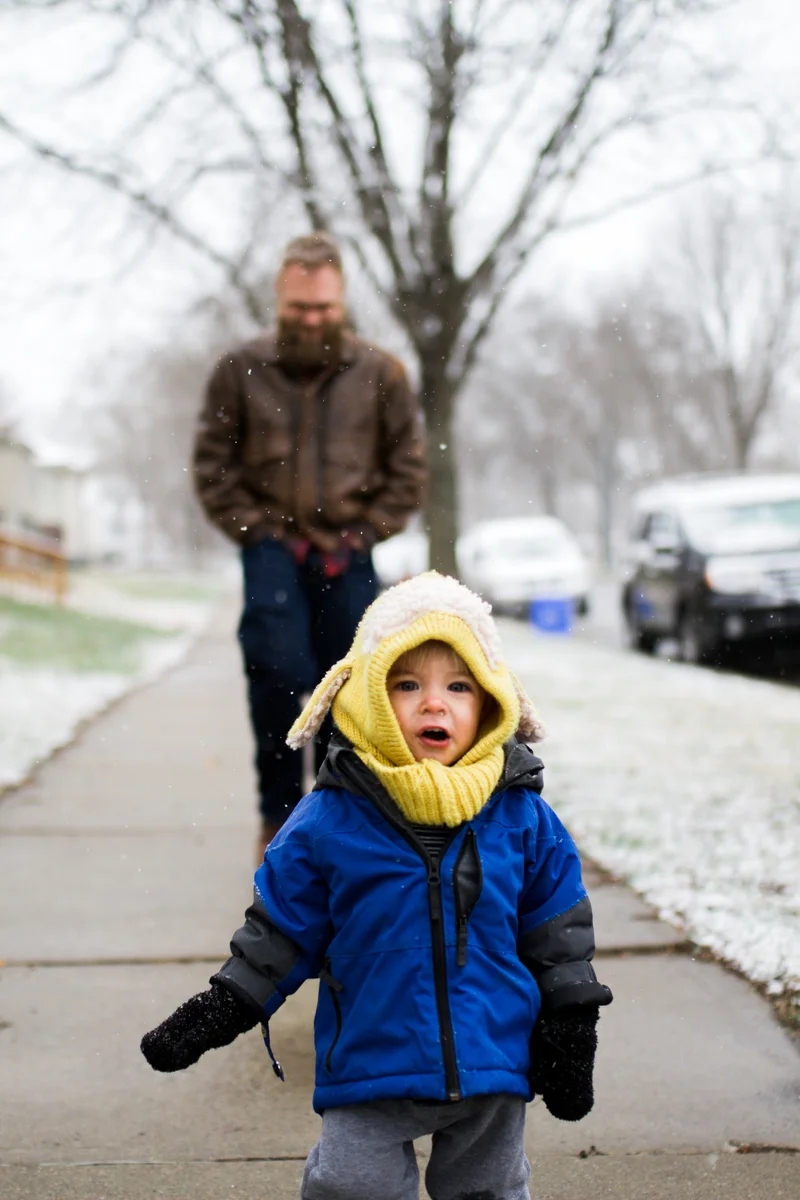 Kansas City, MO lifestyle family photographer father and son in the snow winter family photography