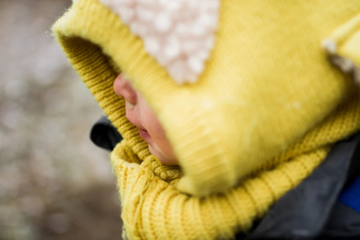 Kansas City, MO lifestyle family photographer toddler in the snow winter family photography close up
