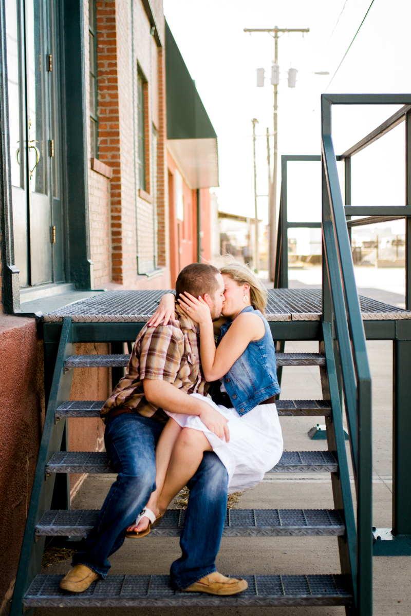  Couples session in Kansas City west bottoms couples photography couple sitting on stairs kissing 