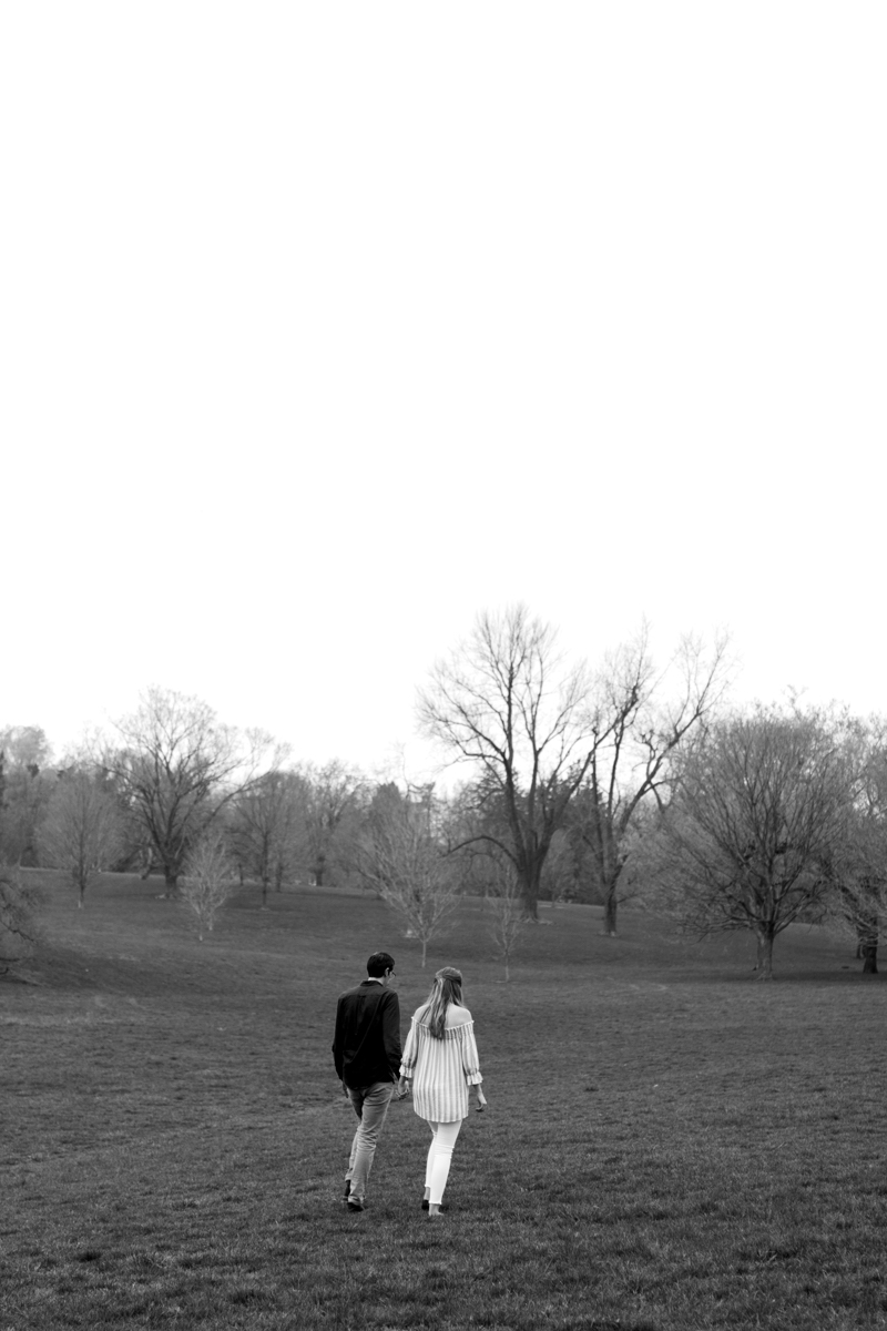  Kansas City Loose Park spring maternity session walking across the hills black and white photo Kansas City Maternity photographer 