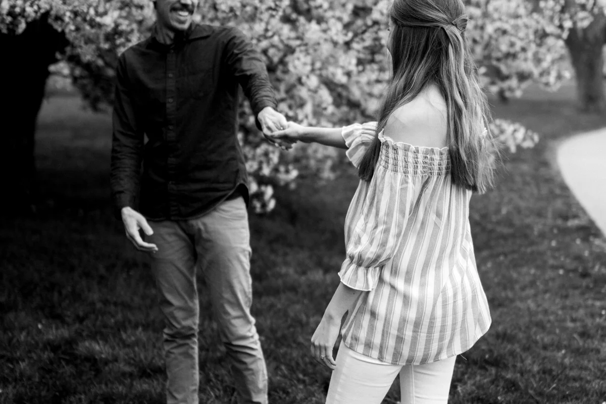 Kansas City Loose Park spring maternity session dancing by the flowering apple tree black and white photo Kansas City maternity photographer
