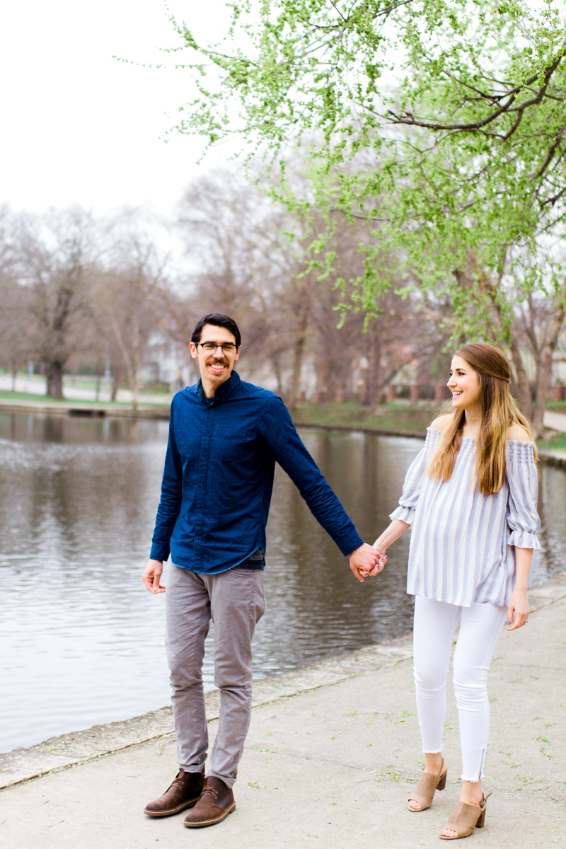  Kansas City Loose Park spring maternity session walking by the pond holding hands Kansas City maternity photographer 
