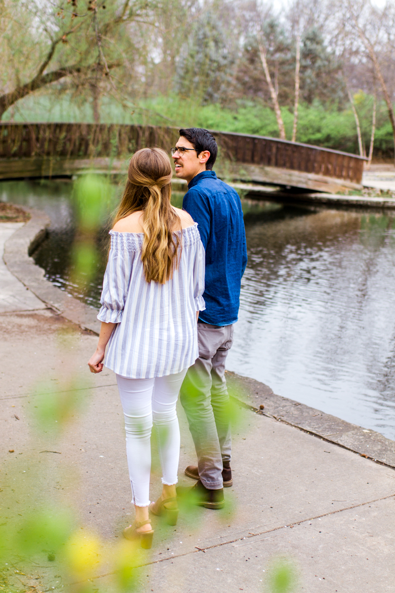  Kansas City Loose Park spring maternity session walking by the pond holding hands Kansas City maternity photographer 