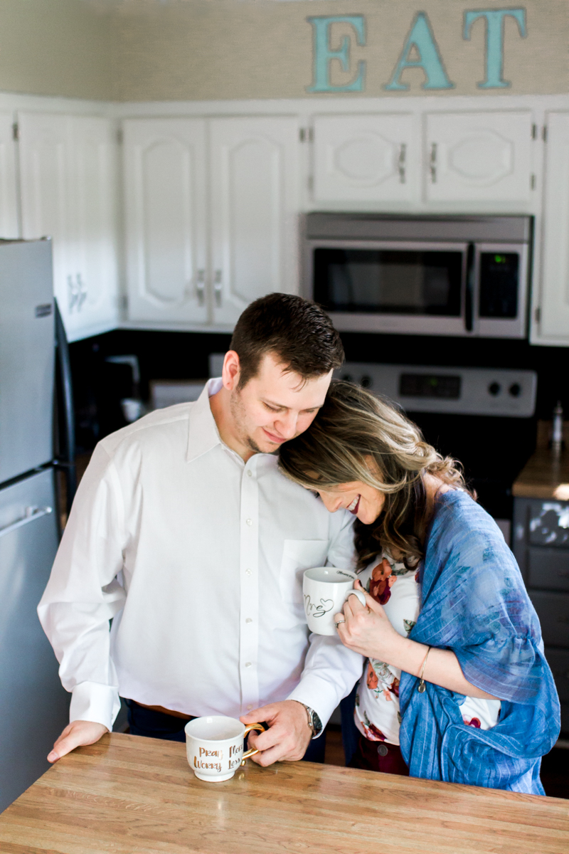  Kansas City lifestyle photographer in home couples session cuddling in the kitchen with coffee engagement photos 