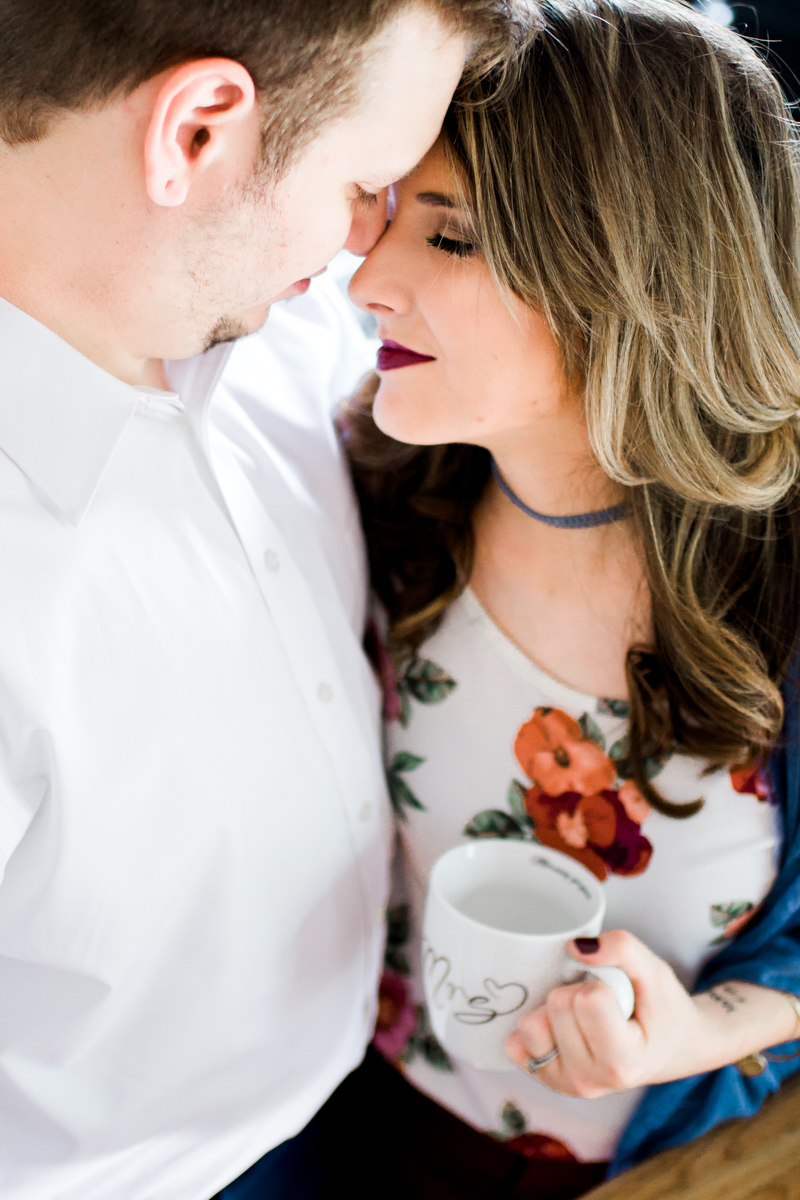  Kansas City lifestyle photographer in home couples session cuddling in the kitchen with coffee engagement photos 
