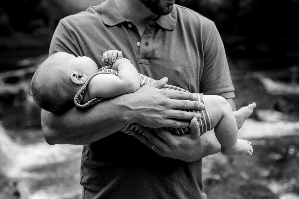  Rebecca Clair Photography Kansas City MO lifestyle family photographer Line Creek Trail Family Session father holding son black and white photo 