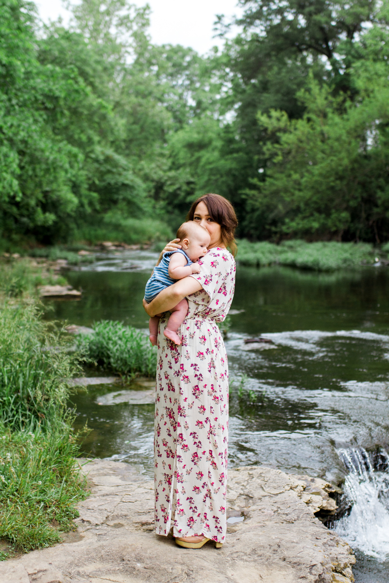  Rebecca Clair Photography Kansas City MO lifestyle family photographer Line Creek Trail Family Session mother holding baby by a waterfall 