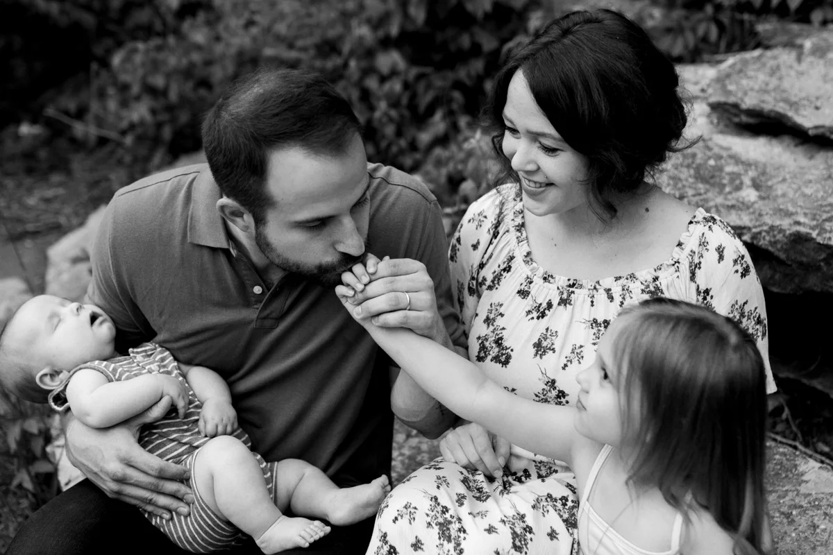Rebecca Clair Photography Kansas City MO lifestyle family photographer Line Creek Trail Family Session father kissing his daughter's hand black and white photo