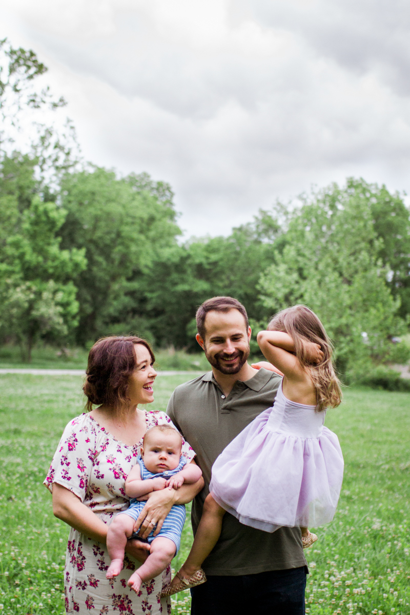  Rebecca Clair Photography Kansas City MO lifestyle family photographer Line Creek Trail Family Session family laughing under stormy skies 
