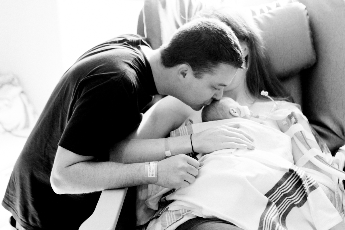  Rebecca Clair Photography lifestyle NICU newborn photography Children's Mercy Hospital dad kissing baby's head black and white photo 