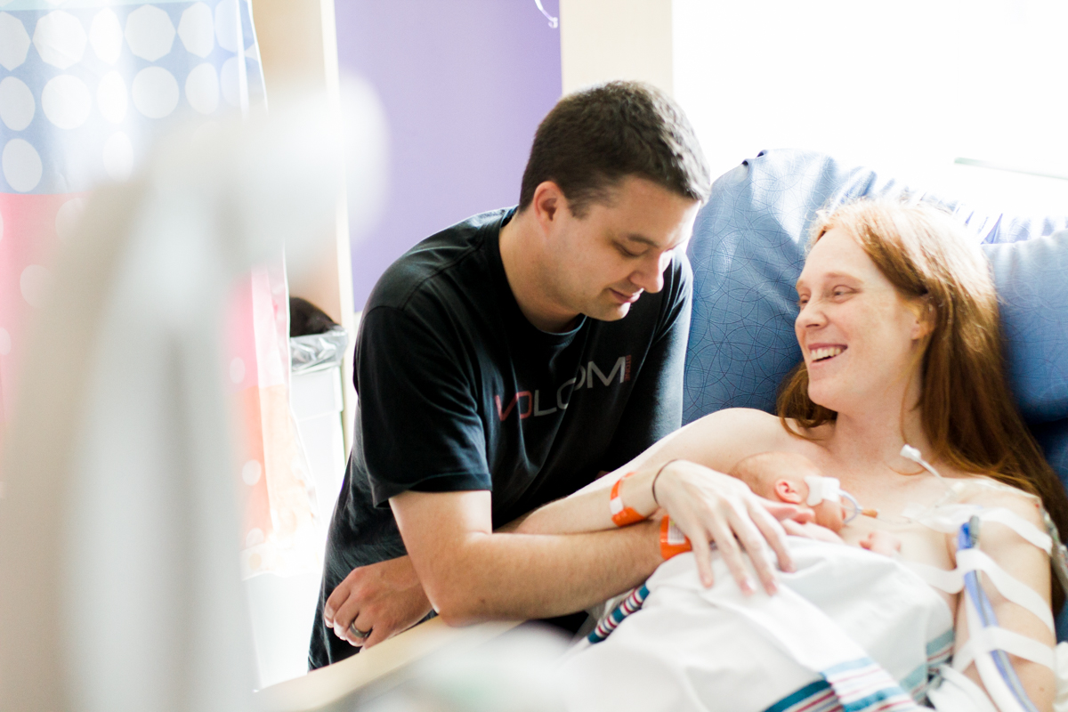  Rebecca Clair Photography lifestyle NICU newborn photography Children's Mercy Hospital parent laughing with their baby 