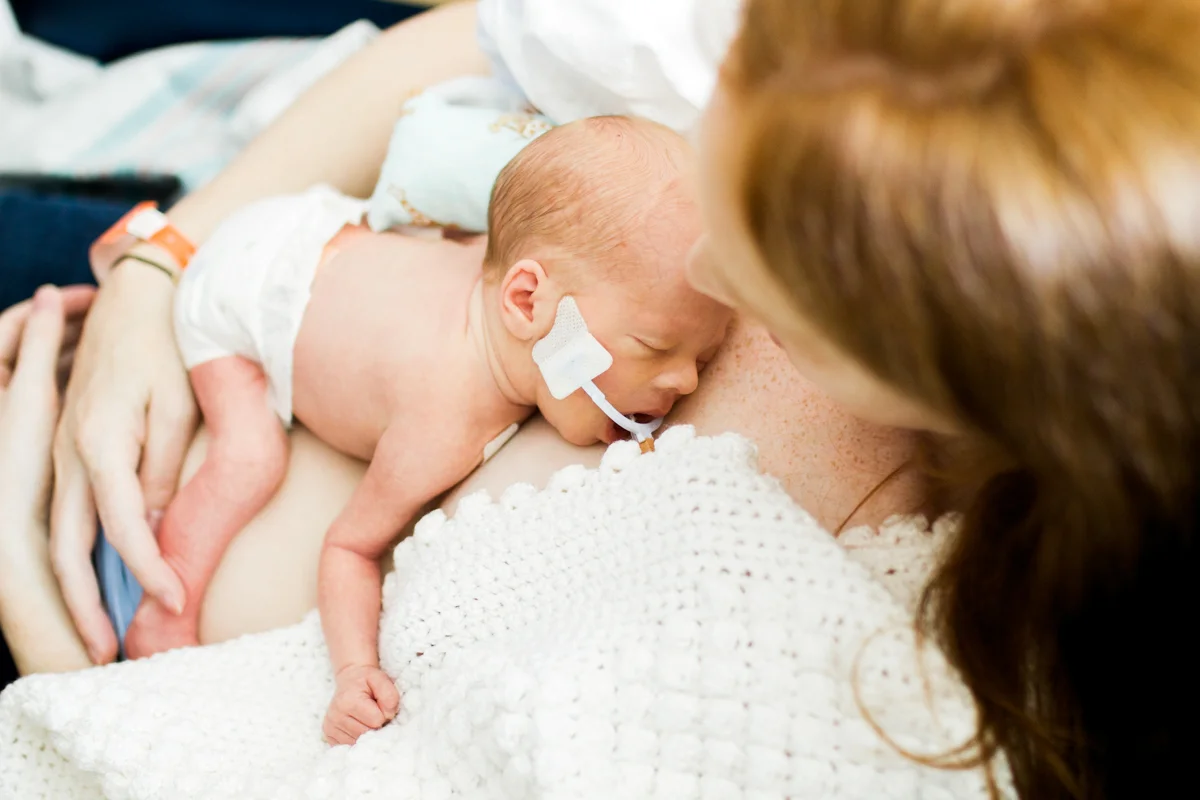 Rebecca Clair Photography lifestyle NICU newborn photography Children's Mercy Hospital mother doing skin to skin with her baby