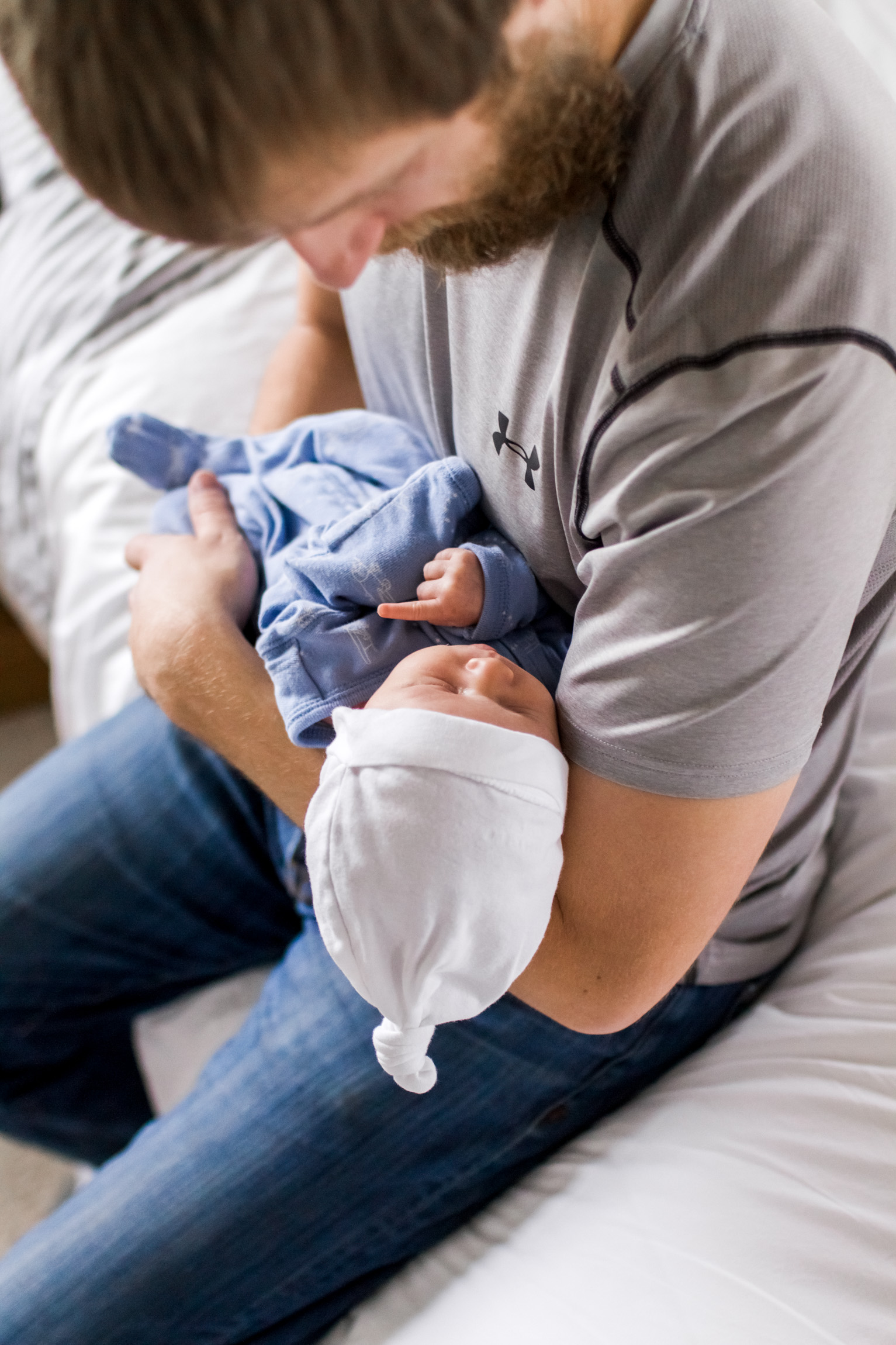  Kansas City lifestyle newborn photographer, Kansas City newborn photographer, Kansas City newborn photos, Kansas City in-hom newborn session, father cuddling baby on bed 