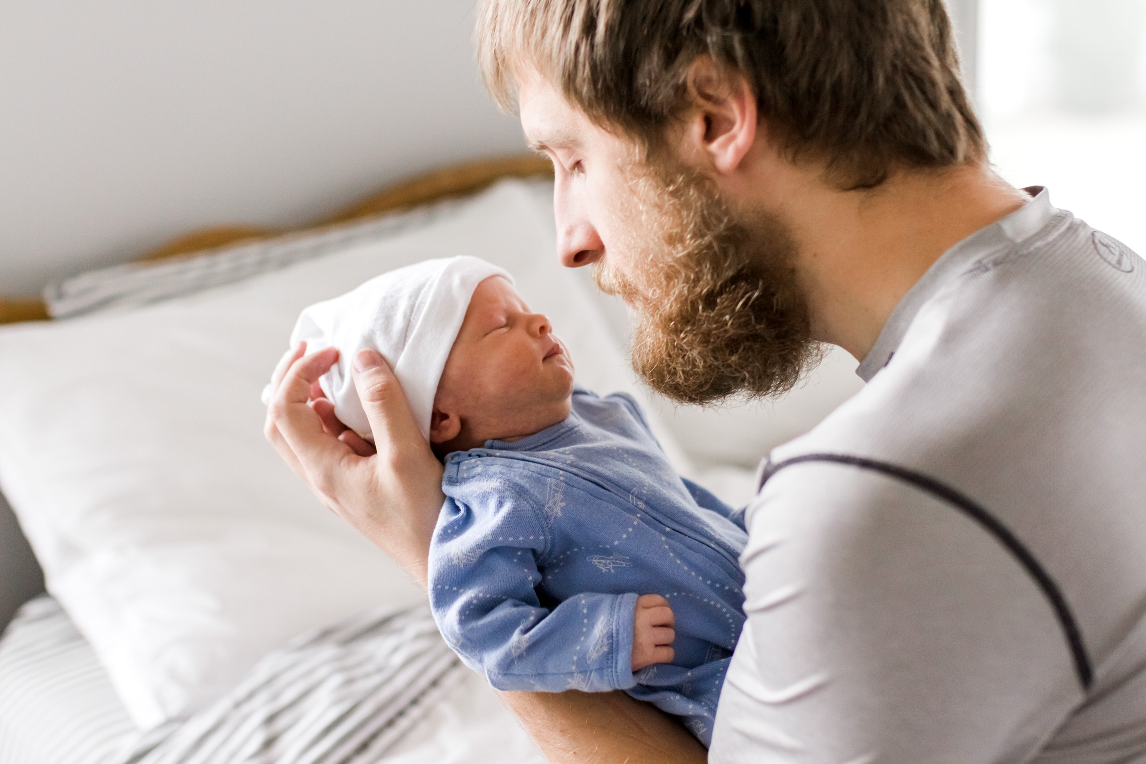  Kansas City lifestyle newborn photographer, Kansas City newborn photographer, Kansas City newborn photos, Kansas City in-hom newborn session, father cuddling baby on bed 