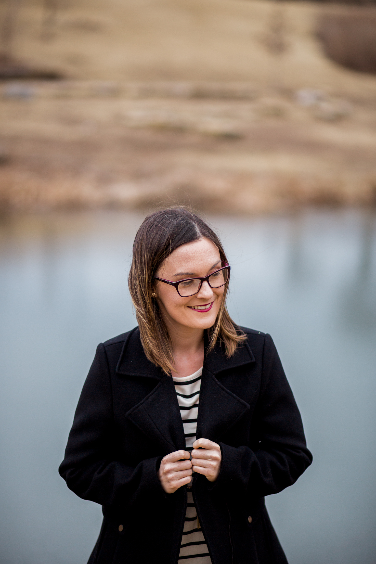  Candid portrait of woman standing by winter pond, Kansas City lifestyle photographer, Kansas City senior photographer, Kansas City small business headshots, Kansas City lifestyle blogger, candid portrait, winter portrait session, Penn Valley Park 