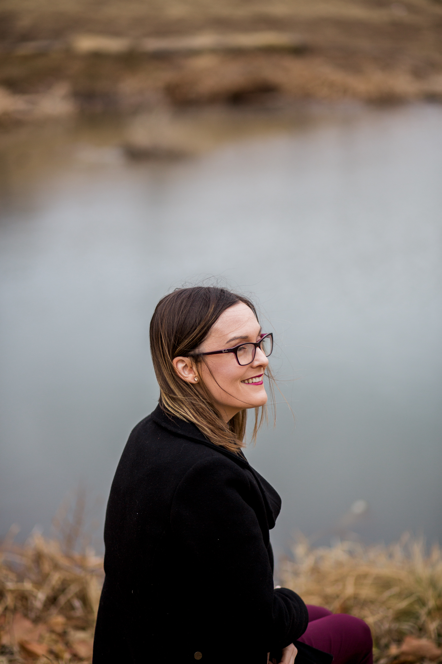  Candid portrait of woman sitting by winter pond, Kansas City lifestyle photographer, Kansas City senior photographer, Kansas City small business headshots, Kansas City lifestyle blogger, candid portrait, winter portrait session, Penn Valley Park 