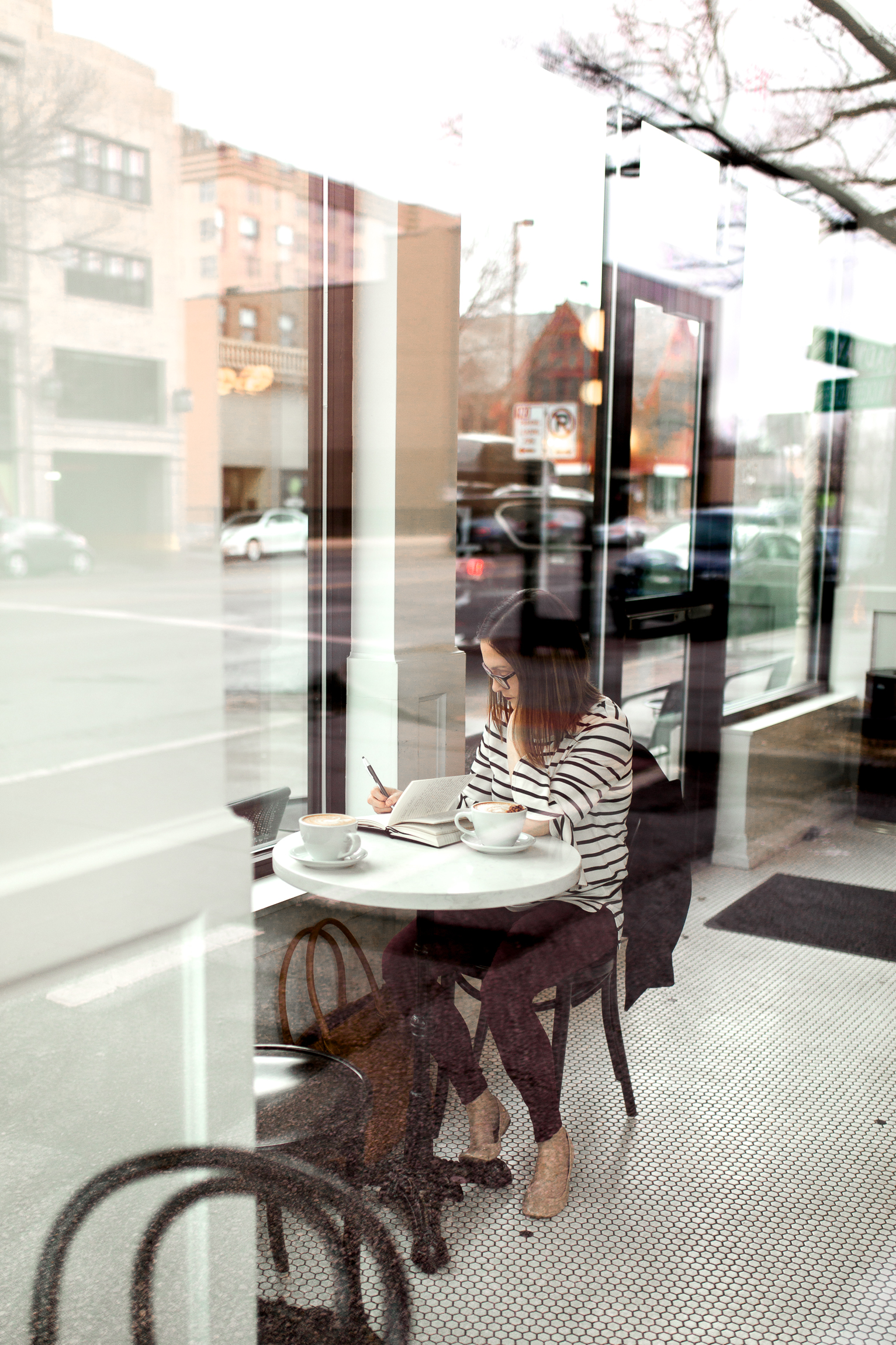  Woman writing in a journal through the window of a coffee shop, Kansas City lifestyle photographer, Kansas City senior photographer, Kansas City small business headshots, Kansas City lifestyle blogger, candid portrait, winter portrait session, Monar