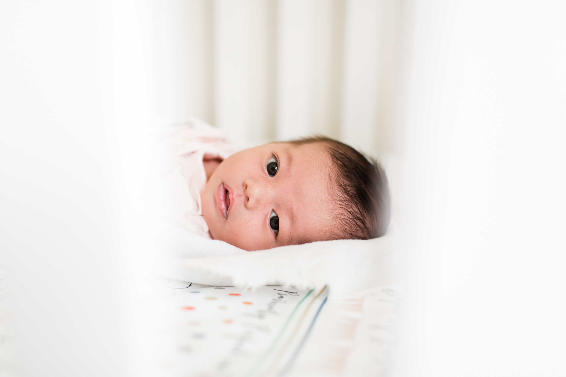  newborn baby in crib, close-up portrait, Kansas City lifestyle newborn photographer, in-home newborn session 