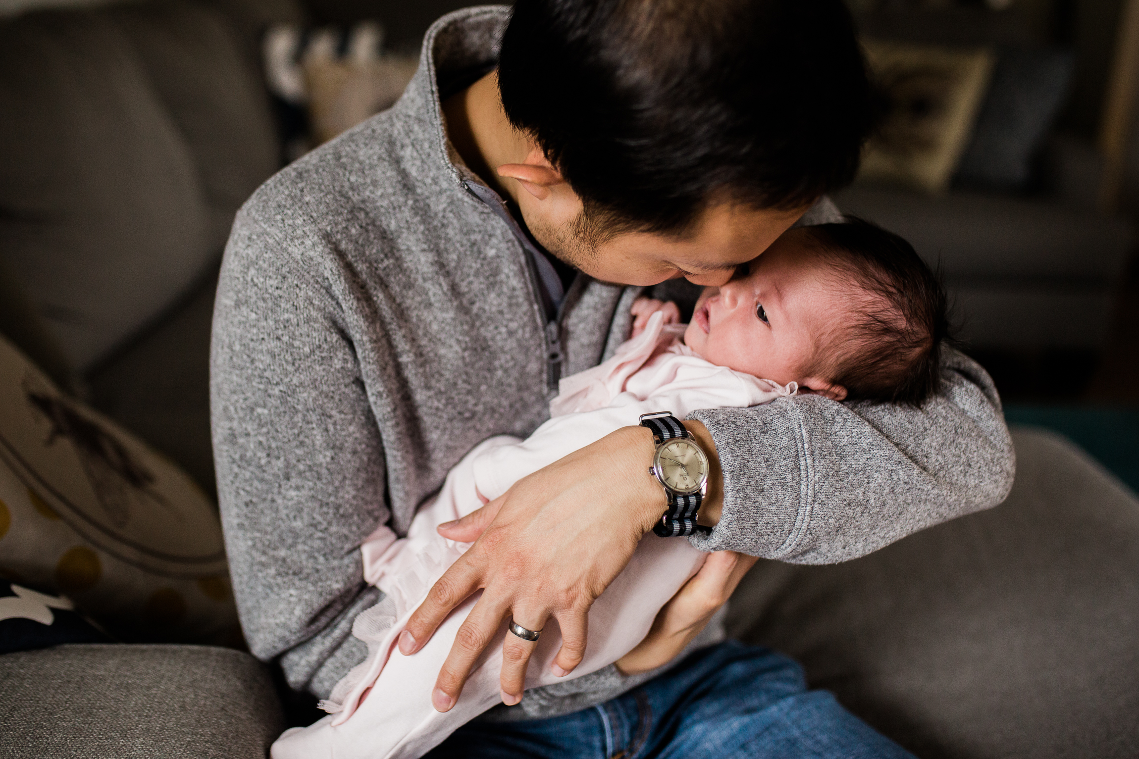  portrait of father cuddling his newborn daughter, Kansas City lifestyle newborn photographer, in-home newborn session 