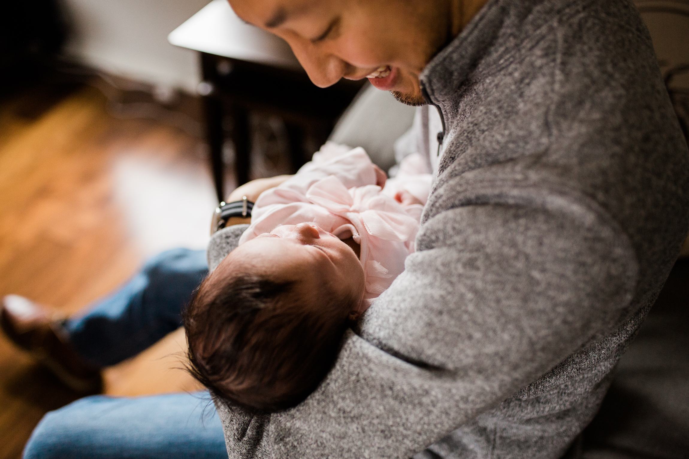  portrait of father cuddling his newborn daughter, Kansas City lifestyle newborn photographer, in-home newborn session 