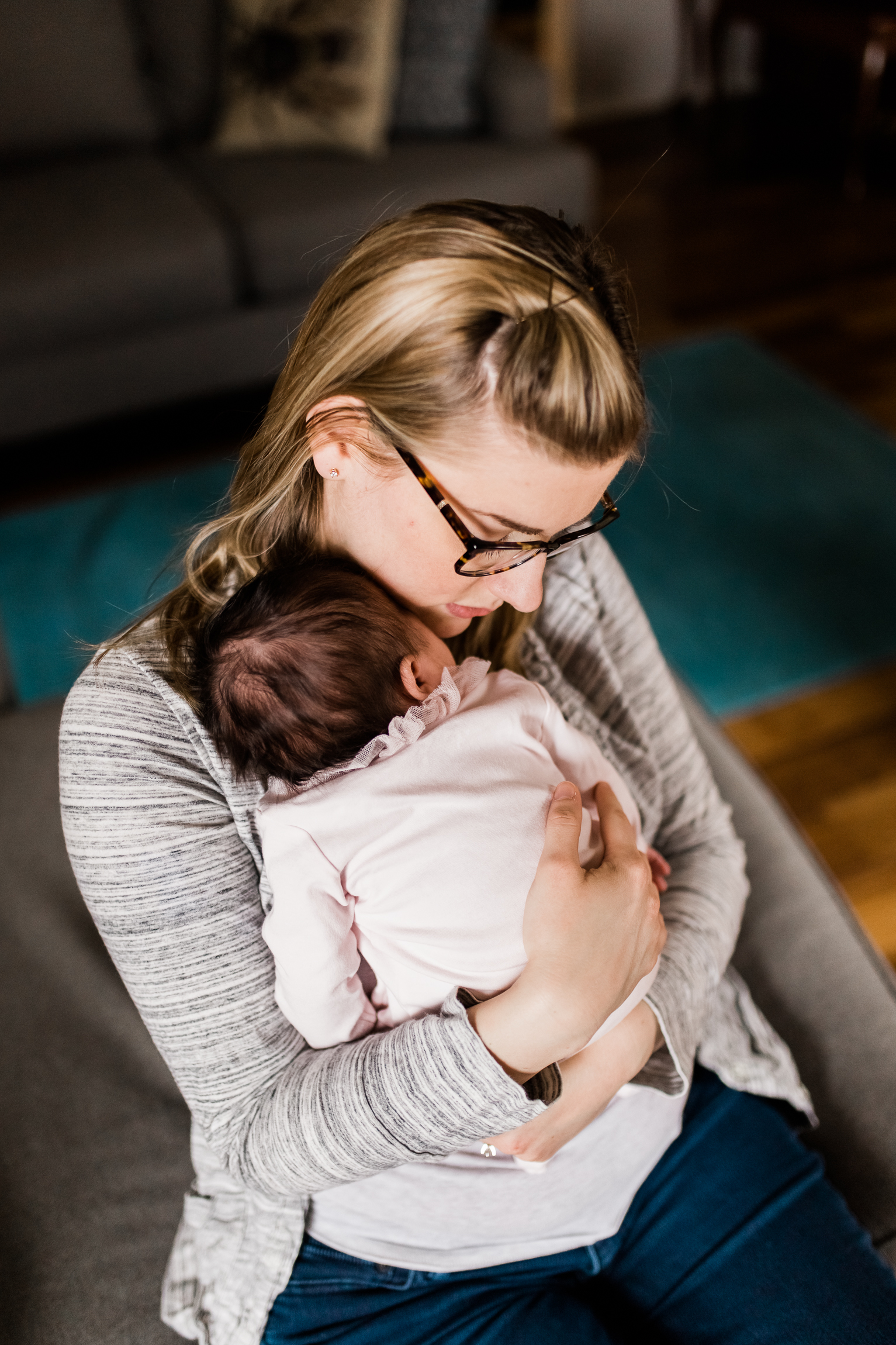  portrait of mother cuddling her newborn daughter, Kansas City lifestyle newborn photographer, in-home newborn session 