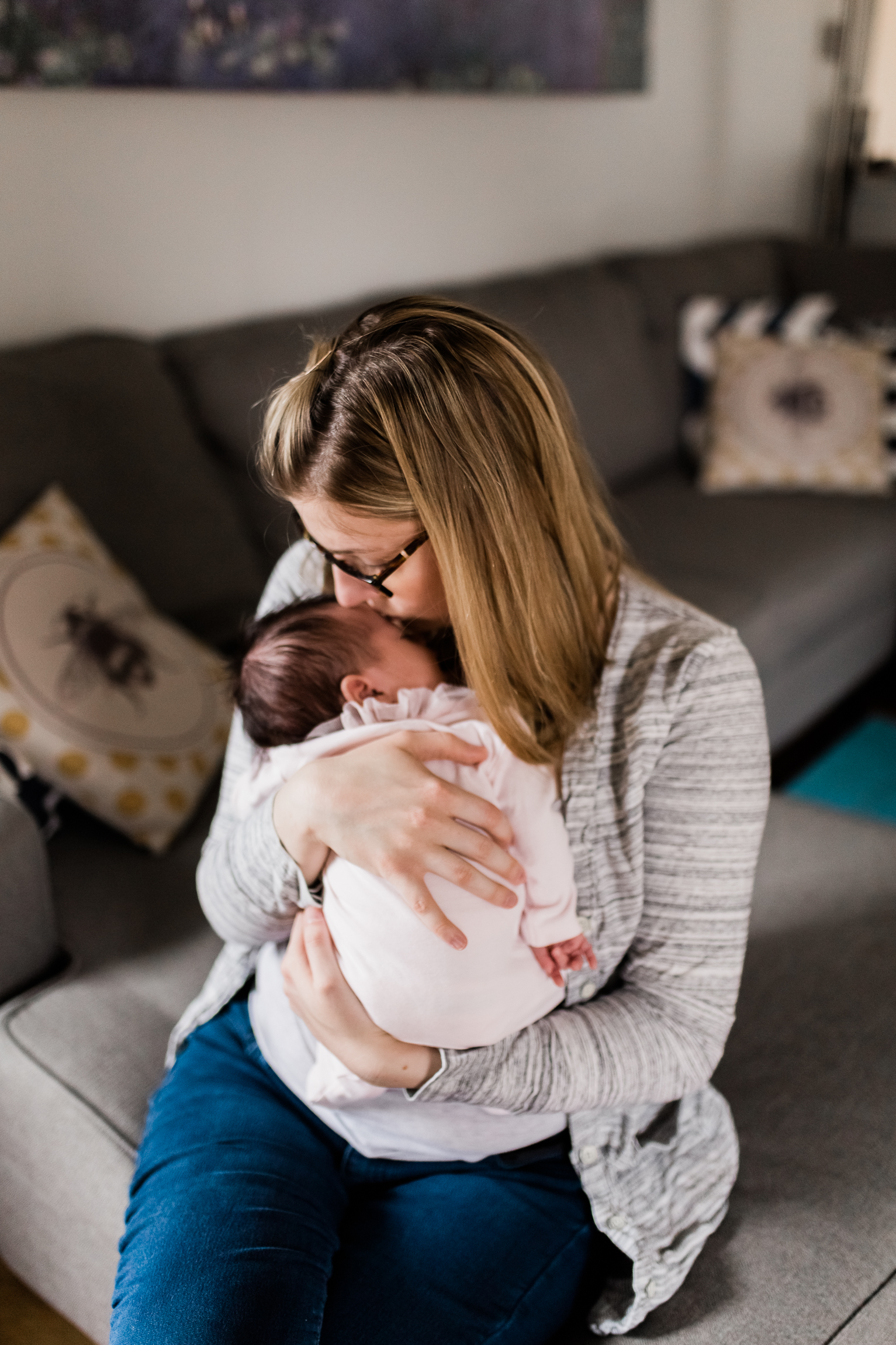  portrait of mother cuddling her newborn daughter, Kansas City lifestyle newborn photographer, in-home newborn session 