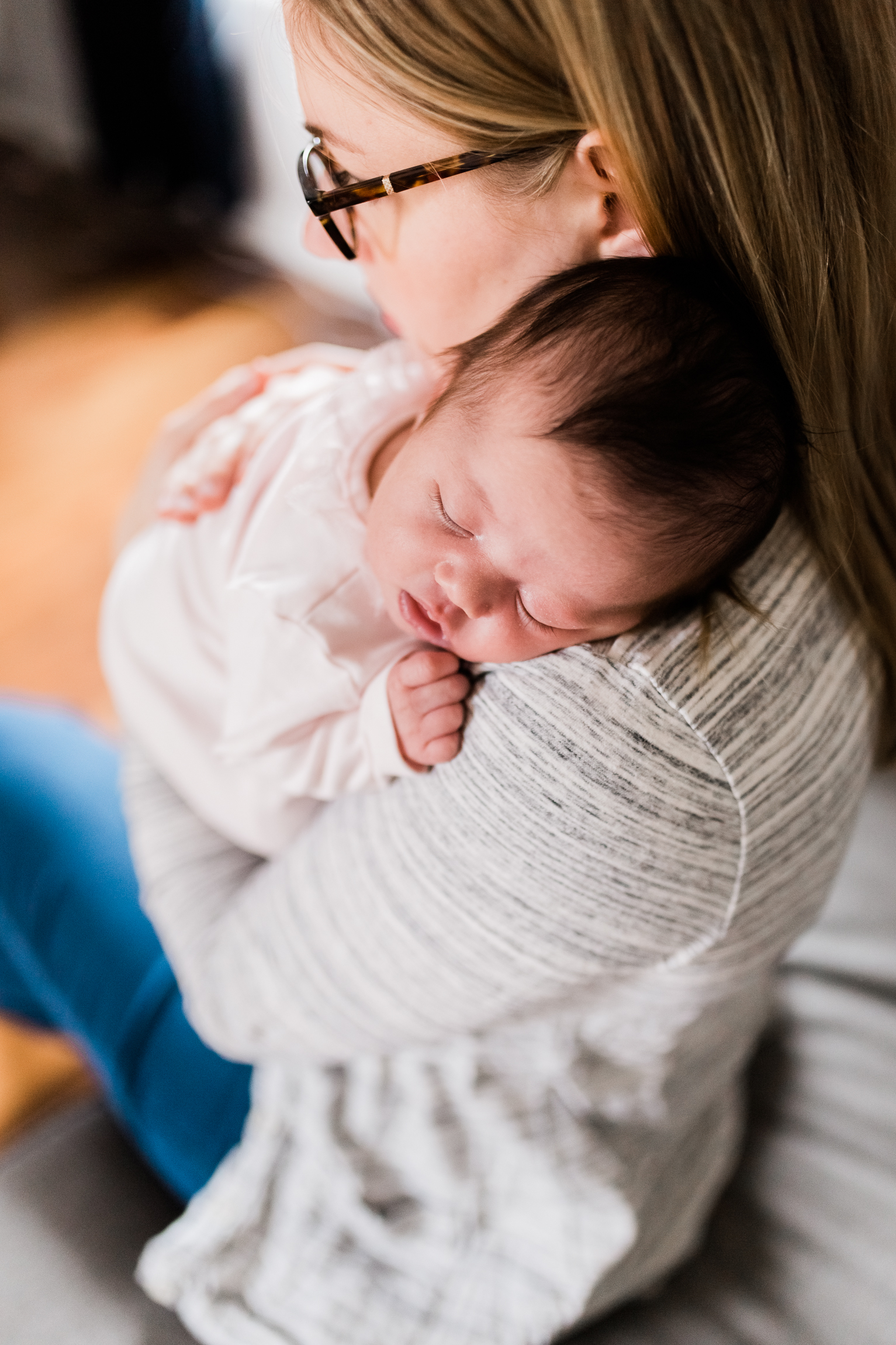  portrait of mother cuddling her newborn daughter, Kansas City lifestyle newborn photographer, in-home newborn session 