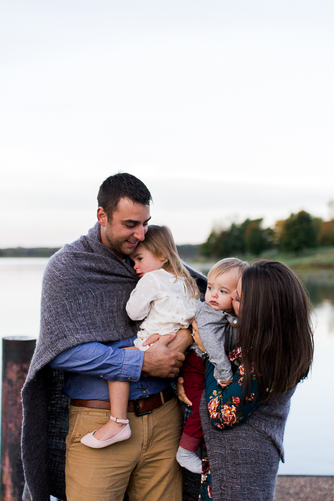  Candid family portrait wrapped in a blanket, sunrise family session at Shawnee Mission Park, Rebecca Clair Photography 