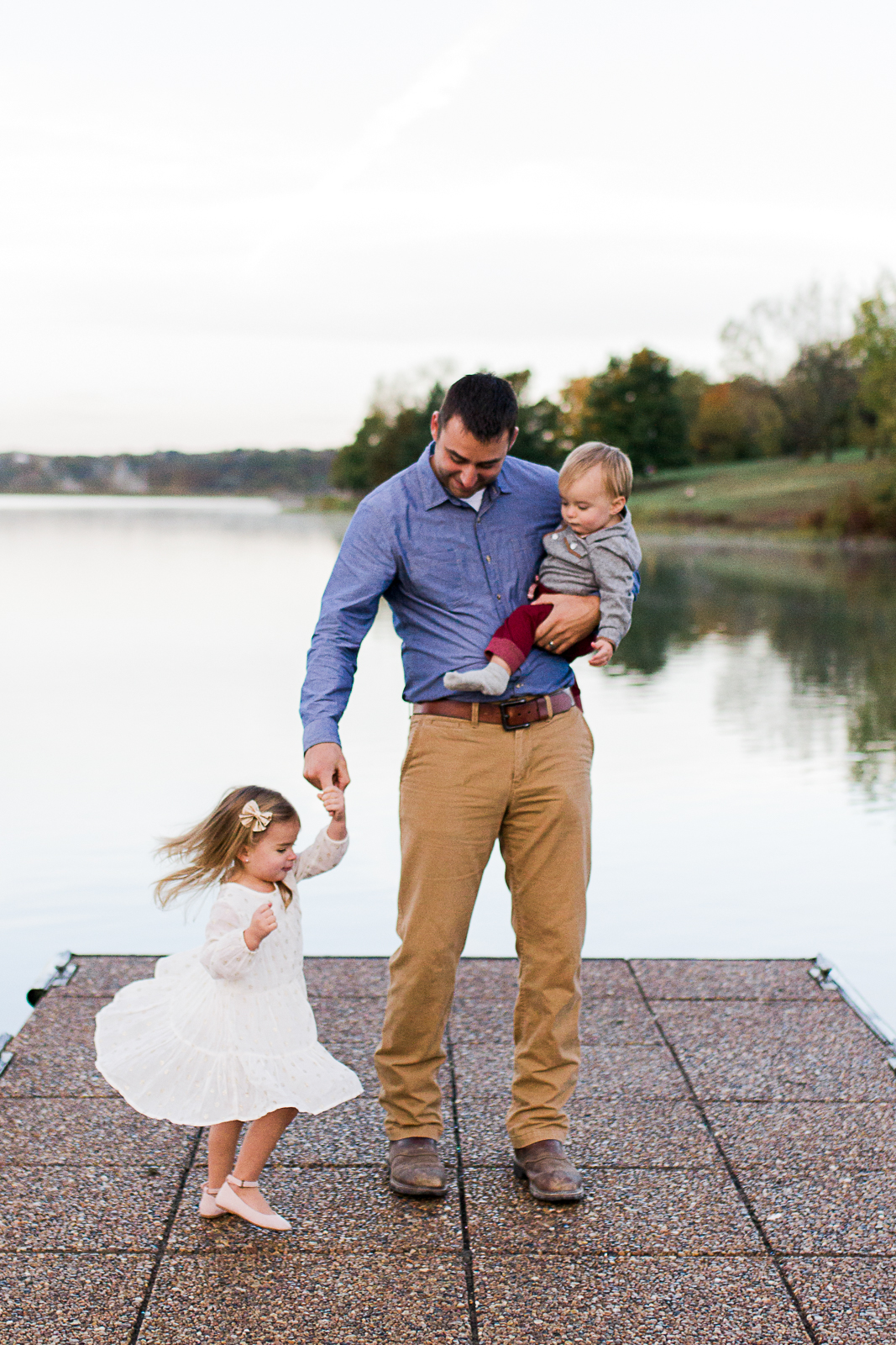  Father dances with his daughter on a dock, Kansas City family photographer, sunrise family session at Shawnee Mission Park, Rebecca Clair Photography 