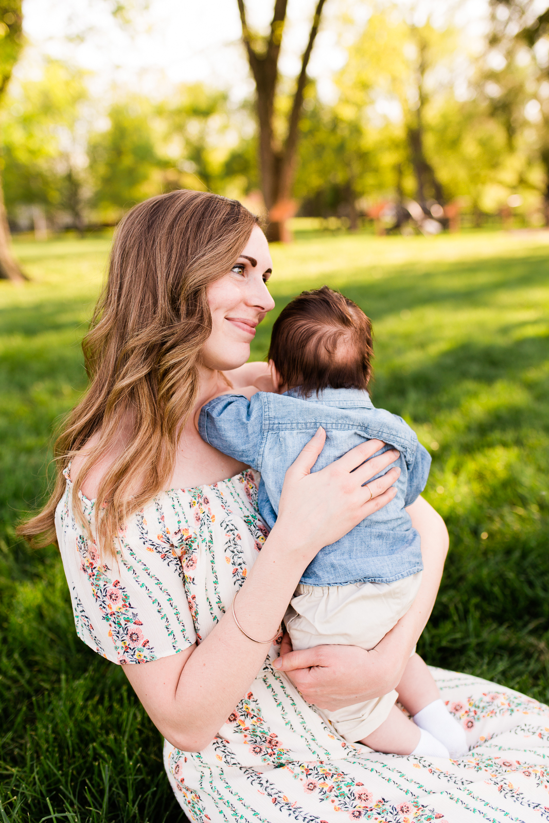  Mother holding baby in the golden evening light, Loose Park family session, Kansas City lifestyle photographer, Rebecca Clair Photography 