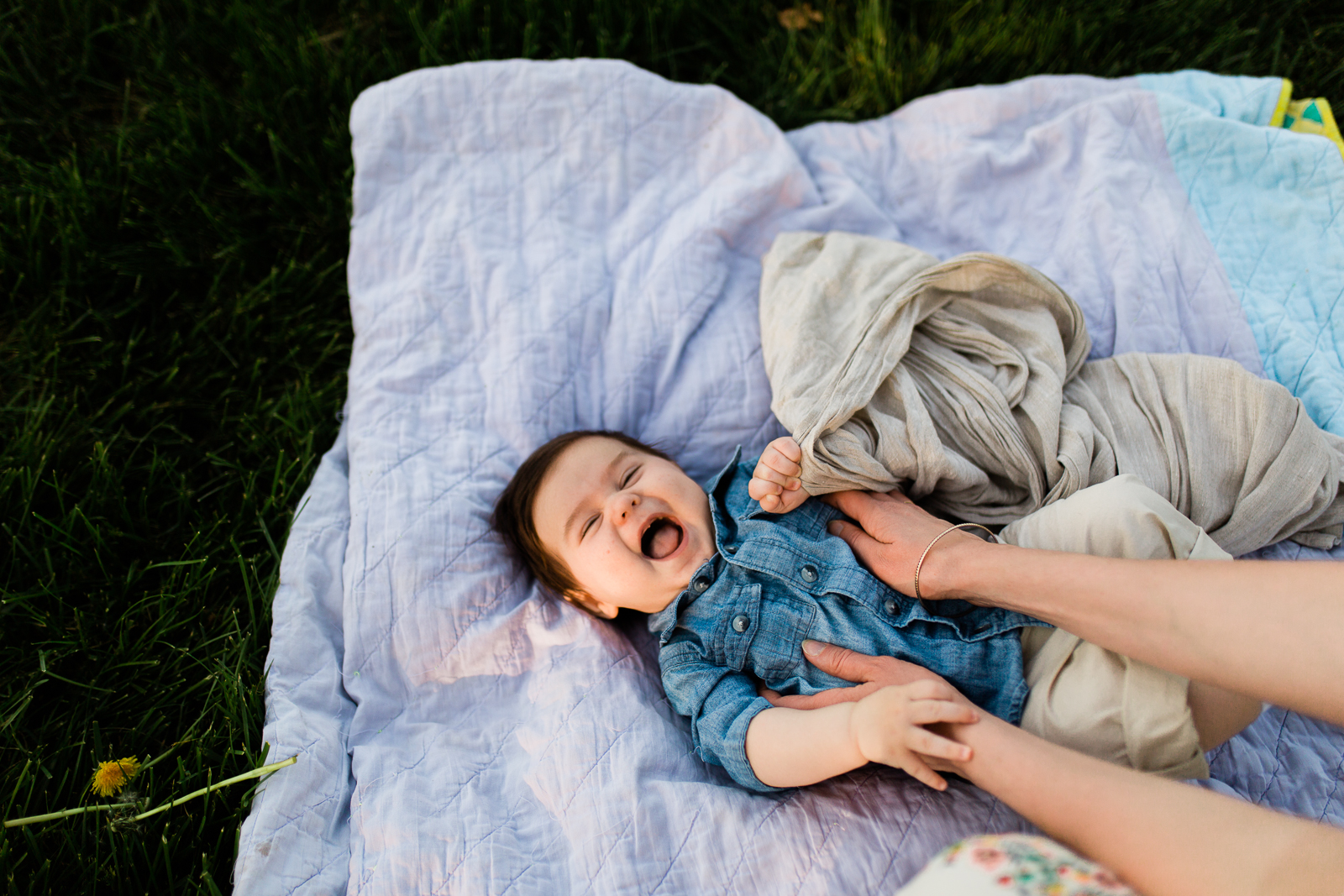  Baby giggles on a quilt in the park, Kansas City lifestyle family photographer, candid family photos, Rebecca Clair Photography 