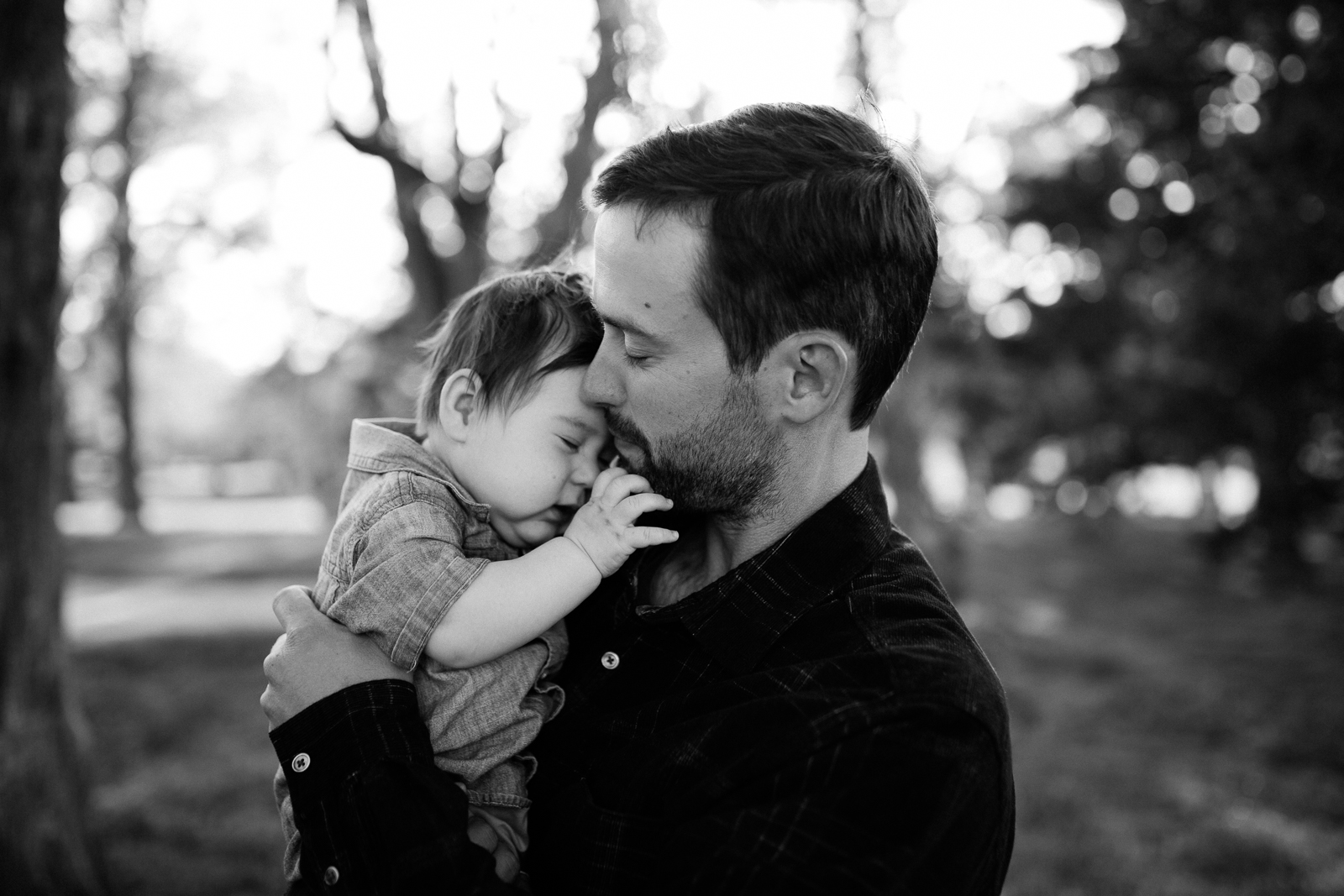  Black and white portrait of father cuddling his son, emotive portrait of father and son, Kansas City family photographer, Rebecca Clair Photography 