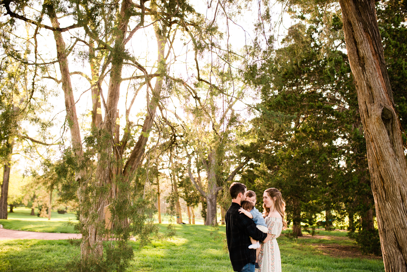  Family portrait in a grove of trees at Loose Park, golden hour family session, Kansas City creative  family photographer, Rebecca Clair Photography 