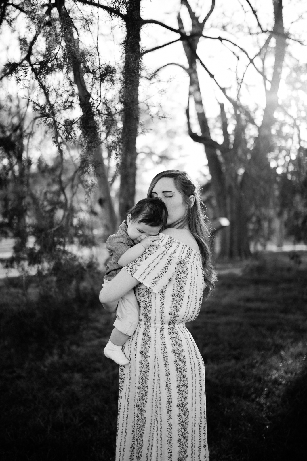  Black and white portrait of mother kissing her baby, emotive family portrait, motherhood portrait, Kansas City creative family photographer, Rebecca Clair Photography 