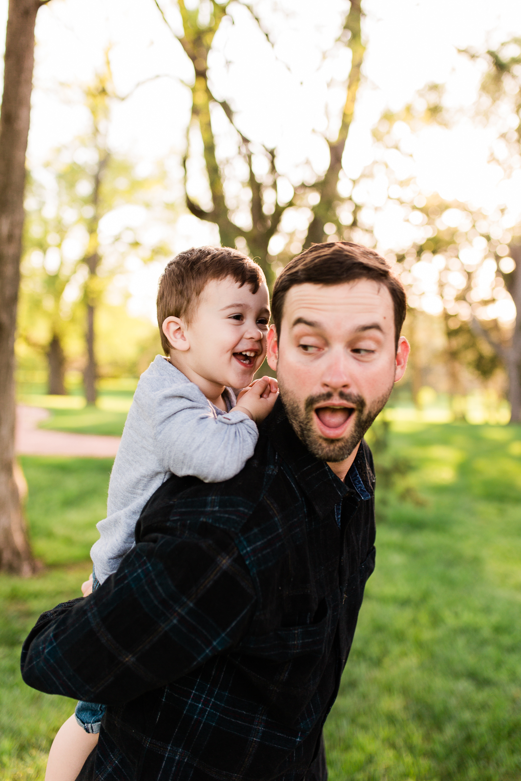  Father gives his son a piggyback ride in the park, Kansas City lifestyle photographer, Rebecca Clair Photography 