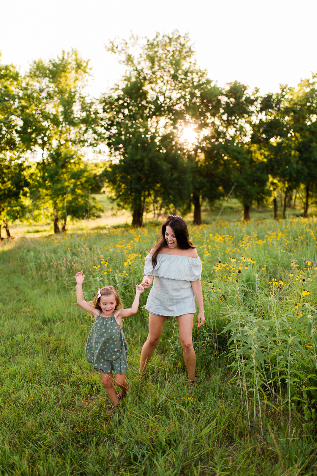  Mother twirls with her daughter, mommy and me session at Shawnee Mission Park, candid family photos in Kansas City 